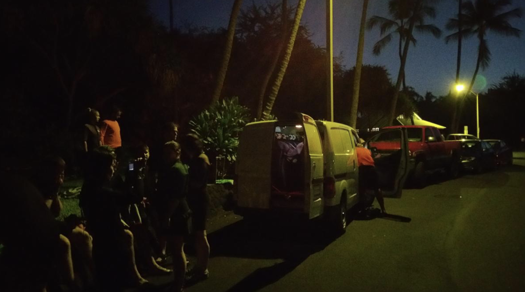 Group puts on wetsuits to prepare for a night snorkel with manta rays off the Kona coast.