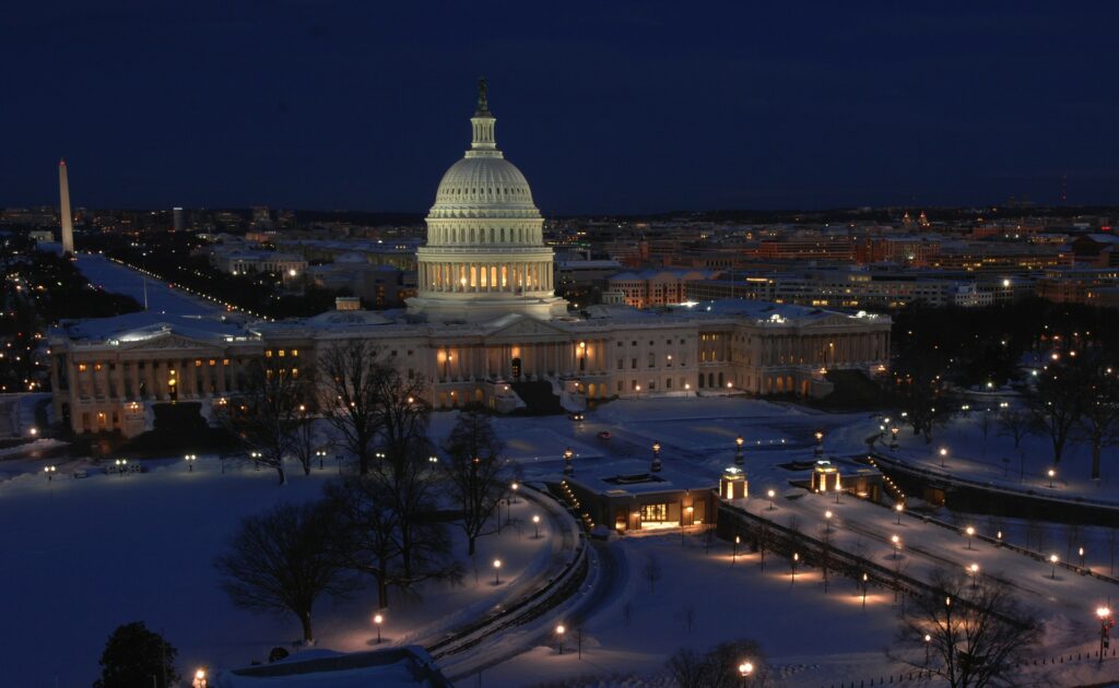 Capitol building in Washington DC at night with snow.