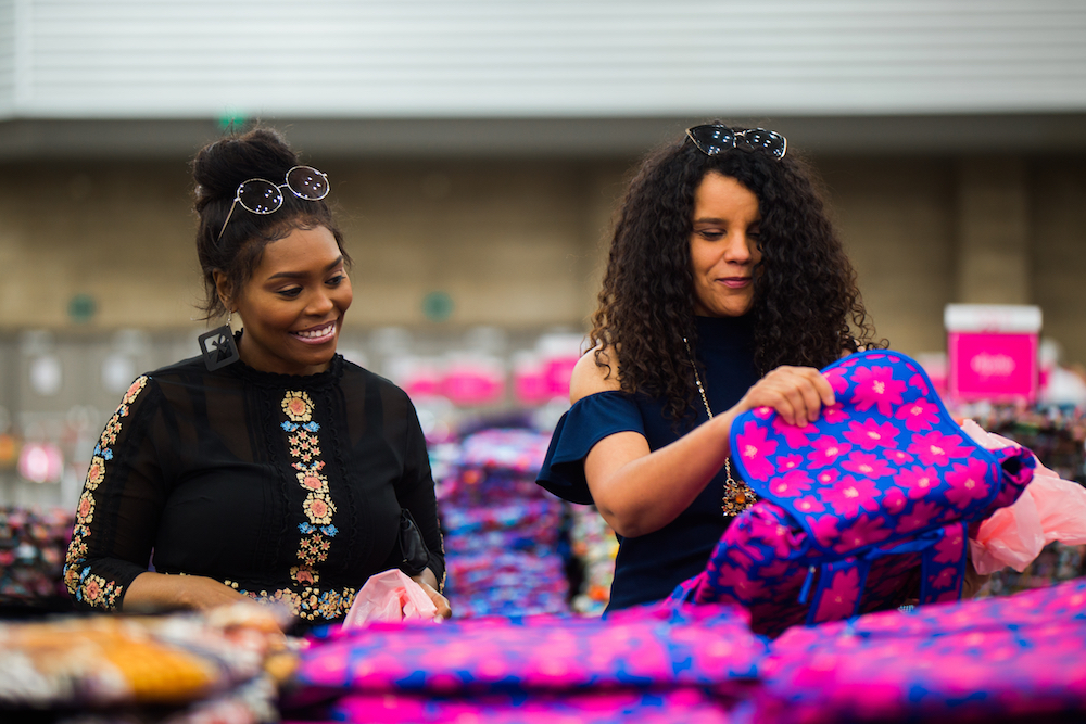Two shoppers compare finds at the Vera Bradley Outlet Sale.