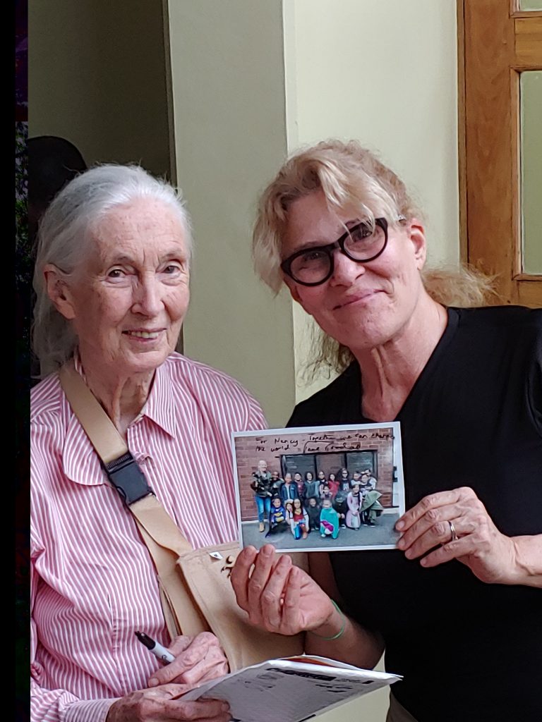 Author presents photo from schoolchildren to Jane Goodall.