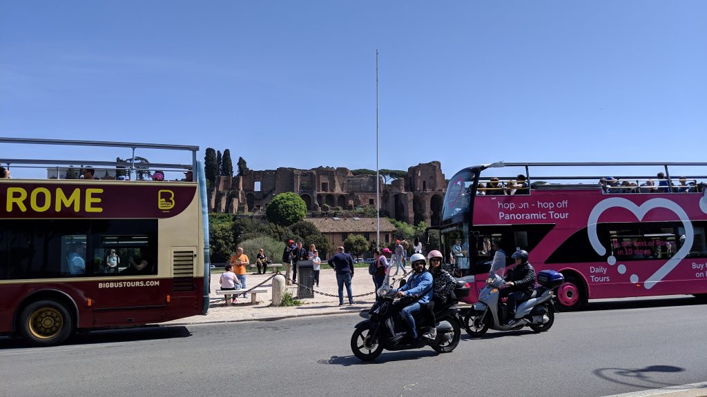 Doubledecker buses stop by Roman Forum.