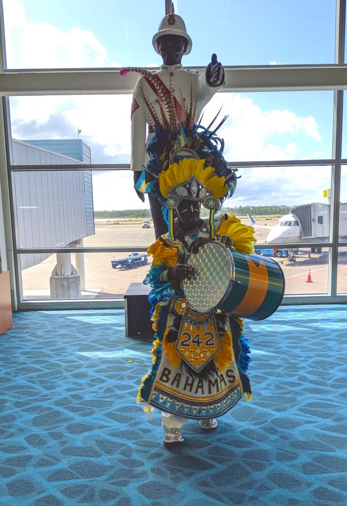 Junkanoo character greets visitors at Nassau Airport.