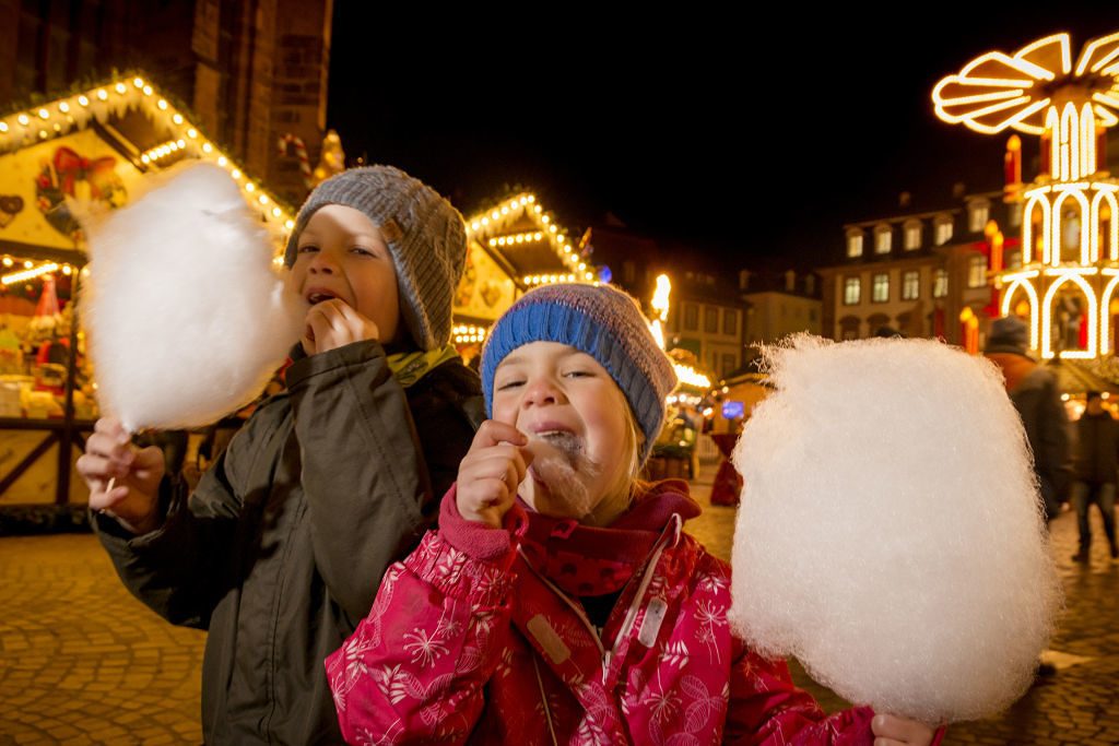 Kids eating cotton candy at Christmas Market