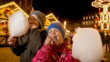 Kids eating cotton candy at Christmas Market