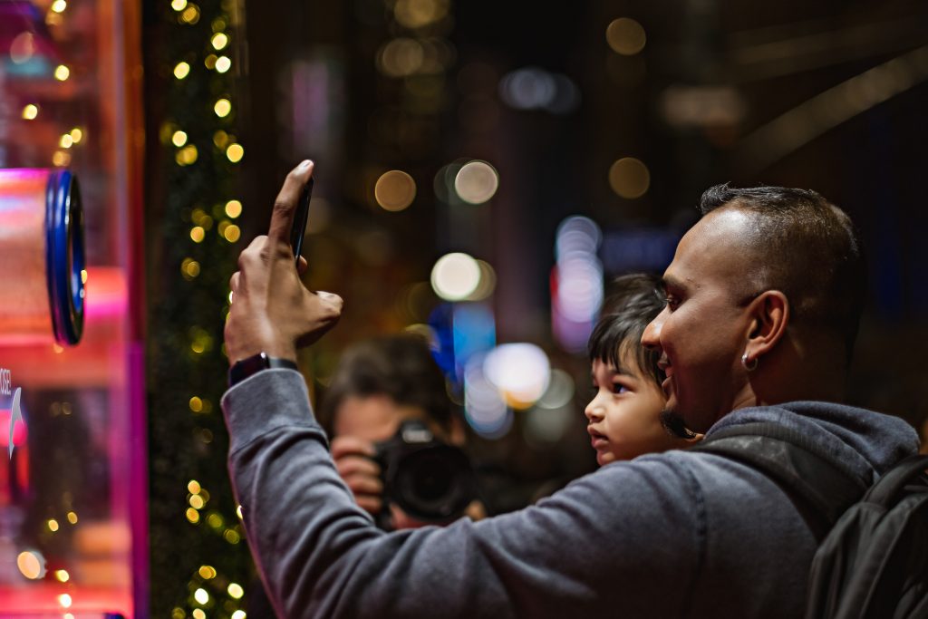 Dad and son watching holiday windows at Macy's Herald Square.