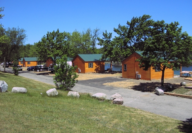 Resort cabins at Camp Dearborn are on the water.