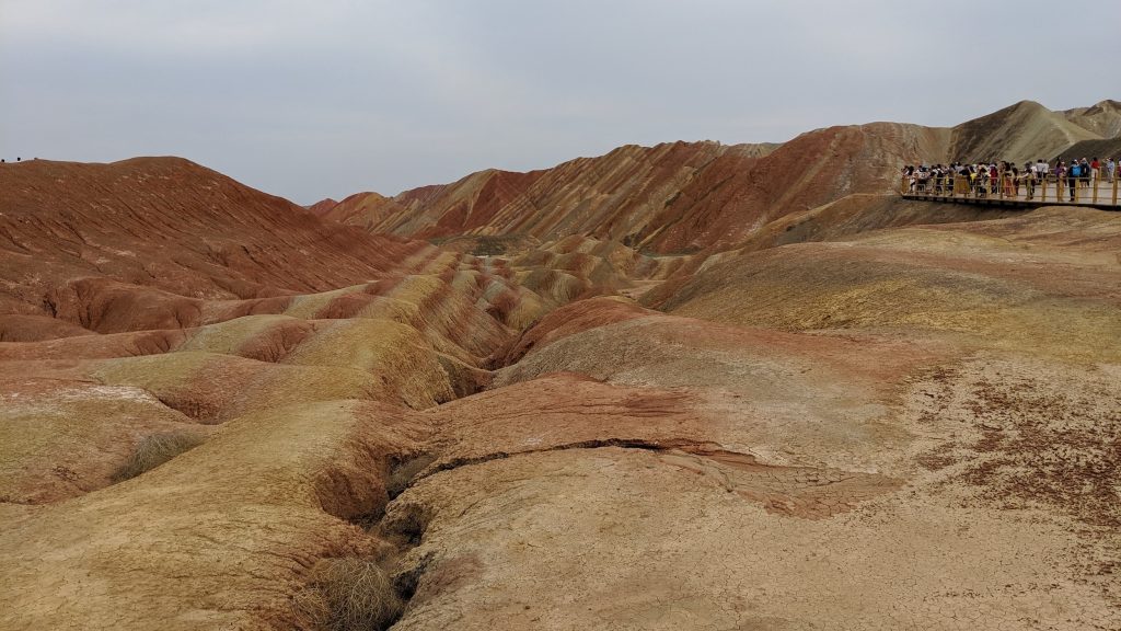 tourists taking pictures of Rainbow Mountain's colors