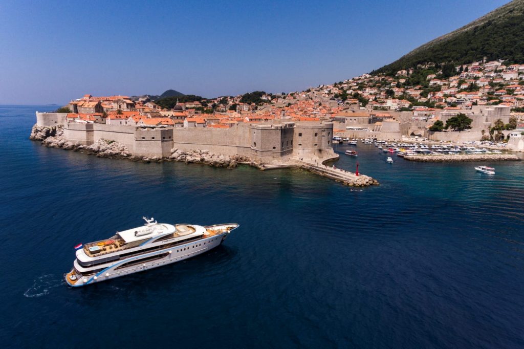 large goolet yacht outside walls of Dubrovnik, one of the best places to sail in the Adriatic Sea.