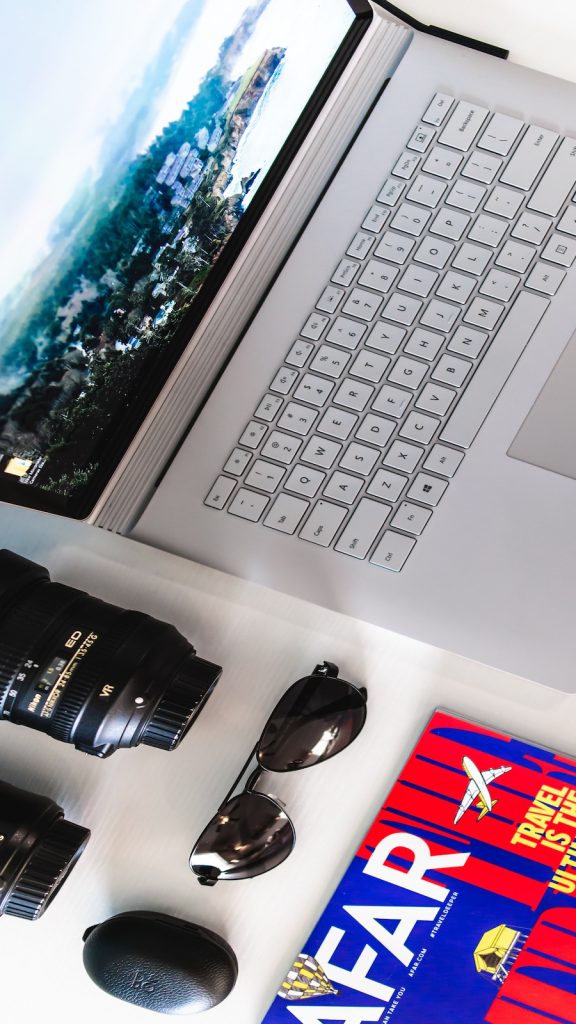 Camera, laptop, travel magazine