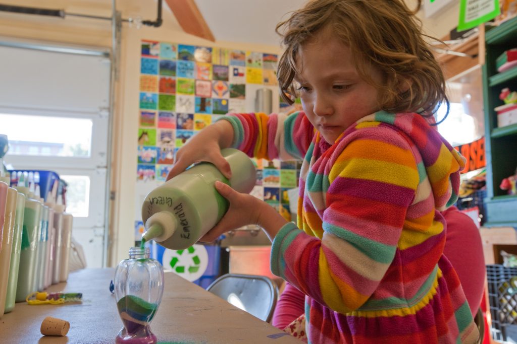 Girl making sand art sculpture at YMCA of the Rockies