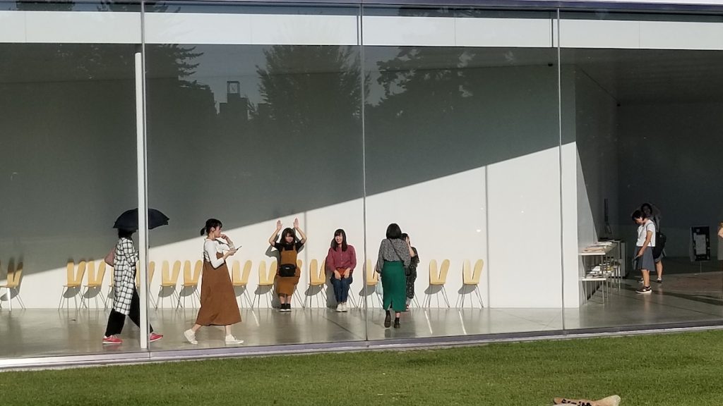 Visitors play with chair sculptures at 21st Century Art Museum in Kanazawa.