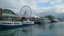 Sightseeing boats and attractions line Chicago's Navy Pier.