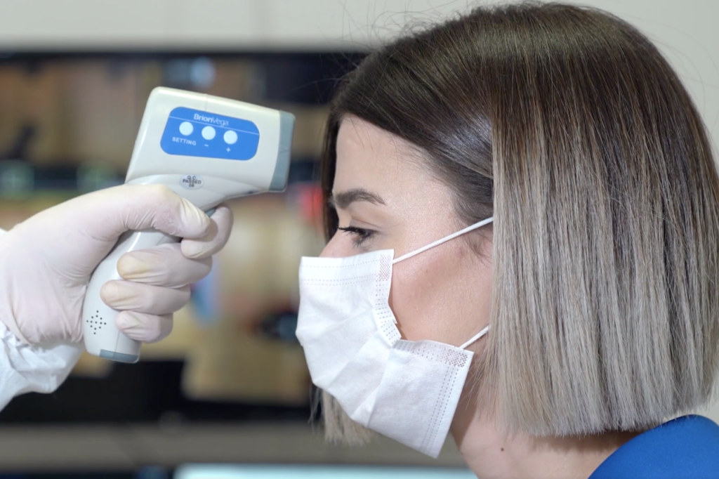 Woman gets temperature check at European airport