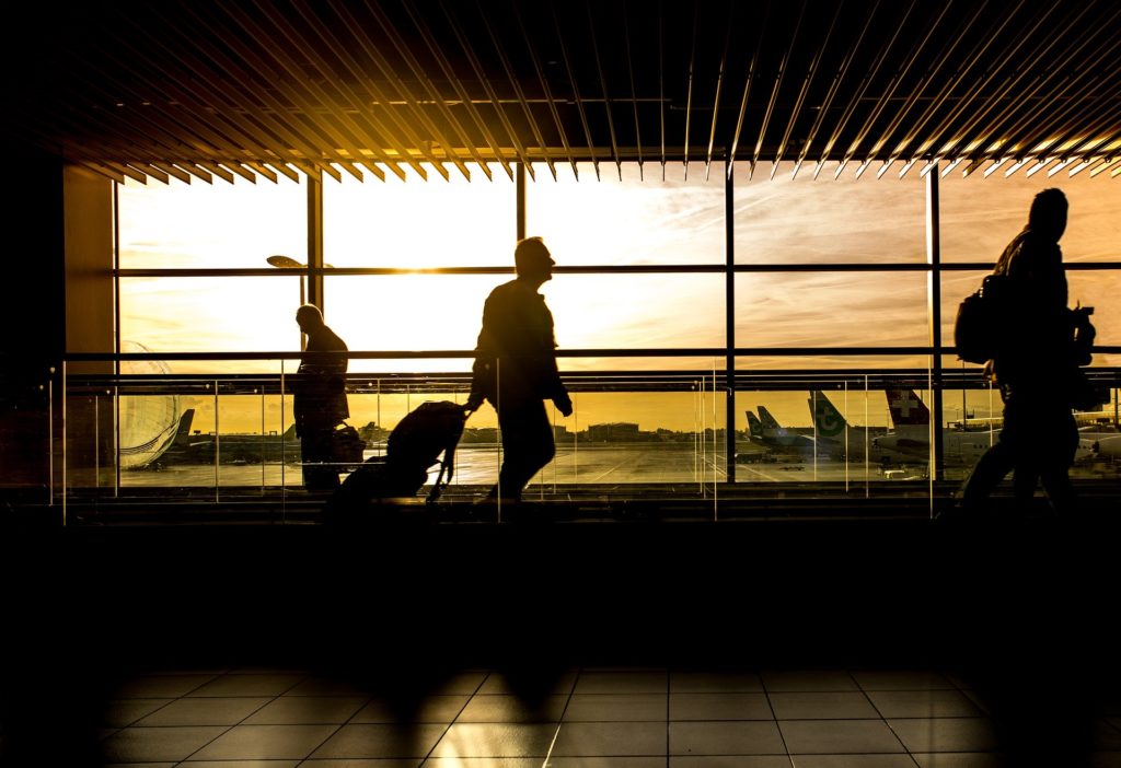 Quiet airport terminal with passengers walking