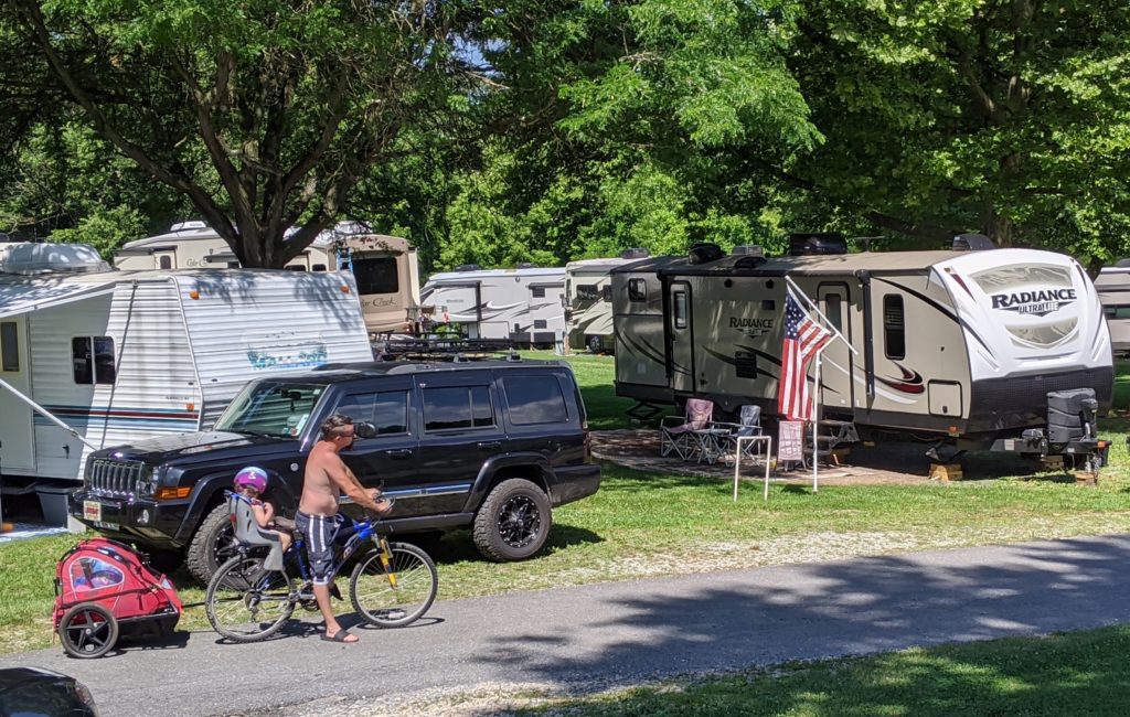 RVs in campground with kids on bikes.