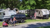 RVs in campground with kids on bikes.