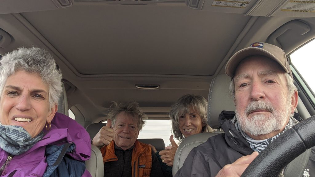 Four seniors driving in SUV in Colorado.