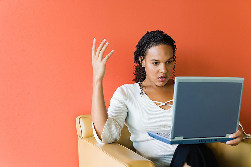 Frustrated woman at computer - best sites for vacation packages
