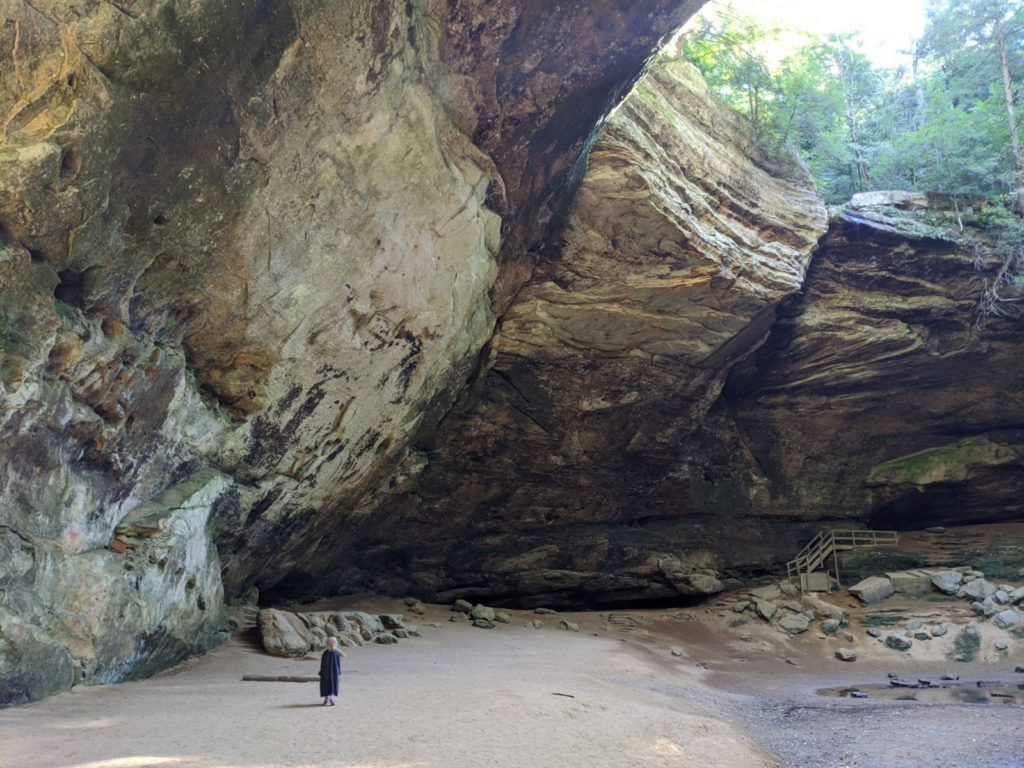Girl tours in the inside of Ash Cave in Hocking Hills State Park, Ohio
