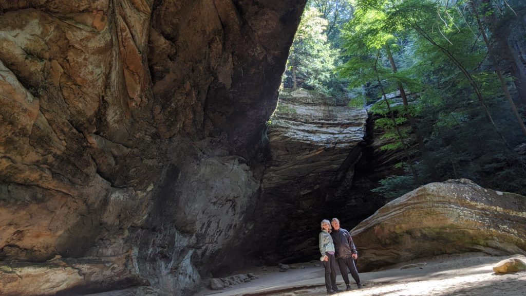 Couple standing inside a recess in Hocking HIlls State Park, Ohio