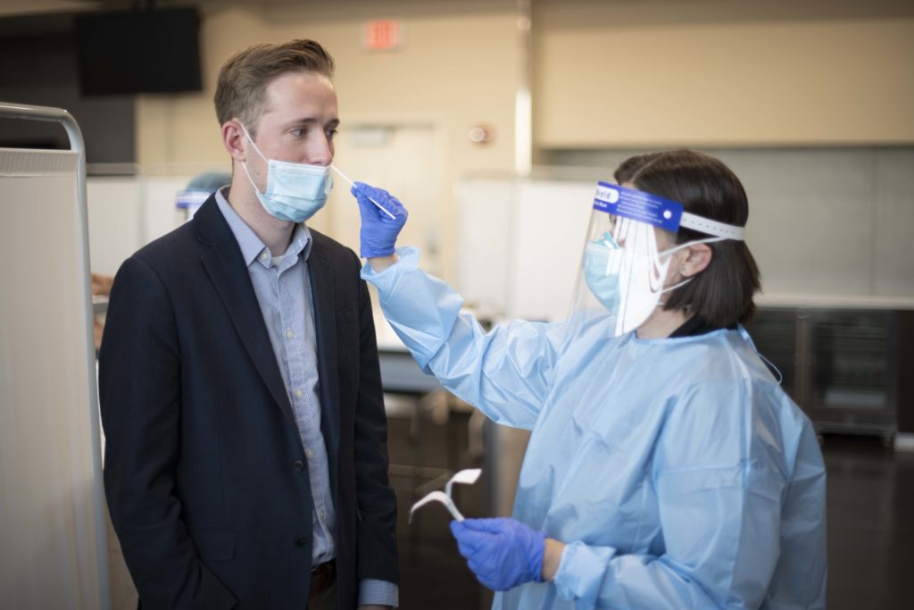 Man in suit gets COVID-19 nasal swab test.