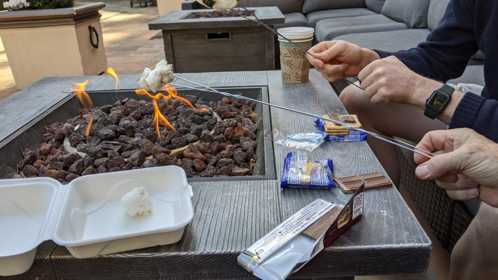 Roasting s'mores over a fire it at Fairmont Sonoma Mission Inn.