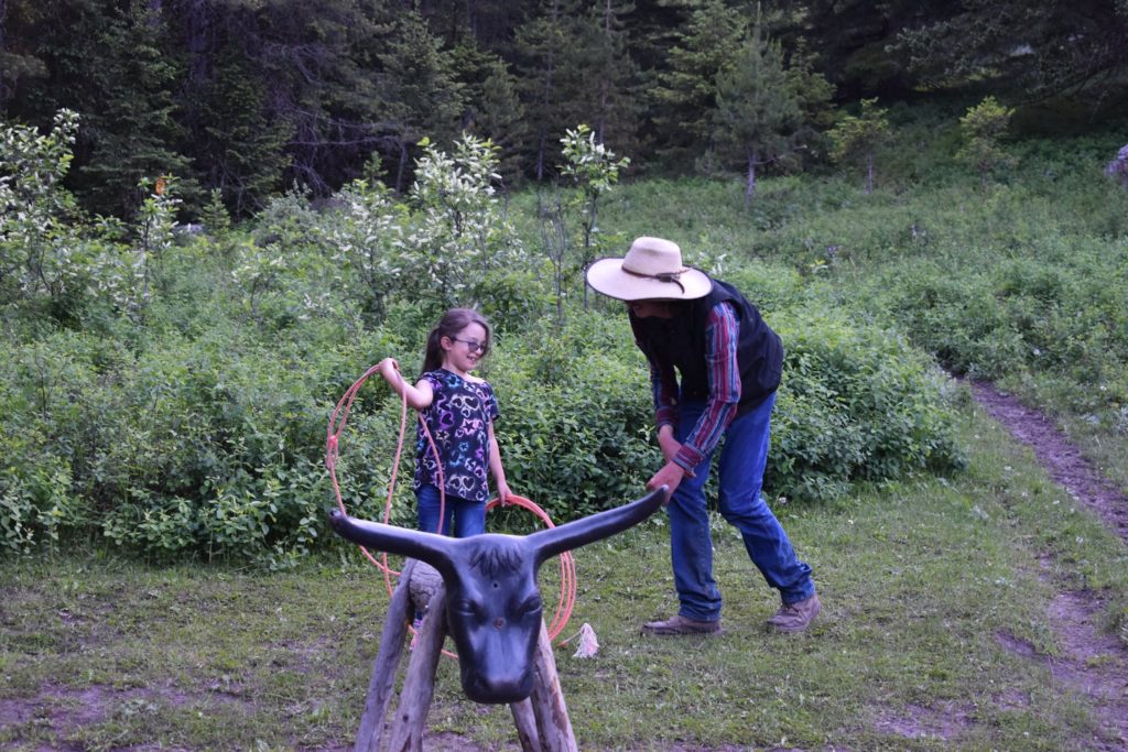 Girl roping a steer's head at Hawley Mountain Guest Ranch in McLeod, Montana.