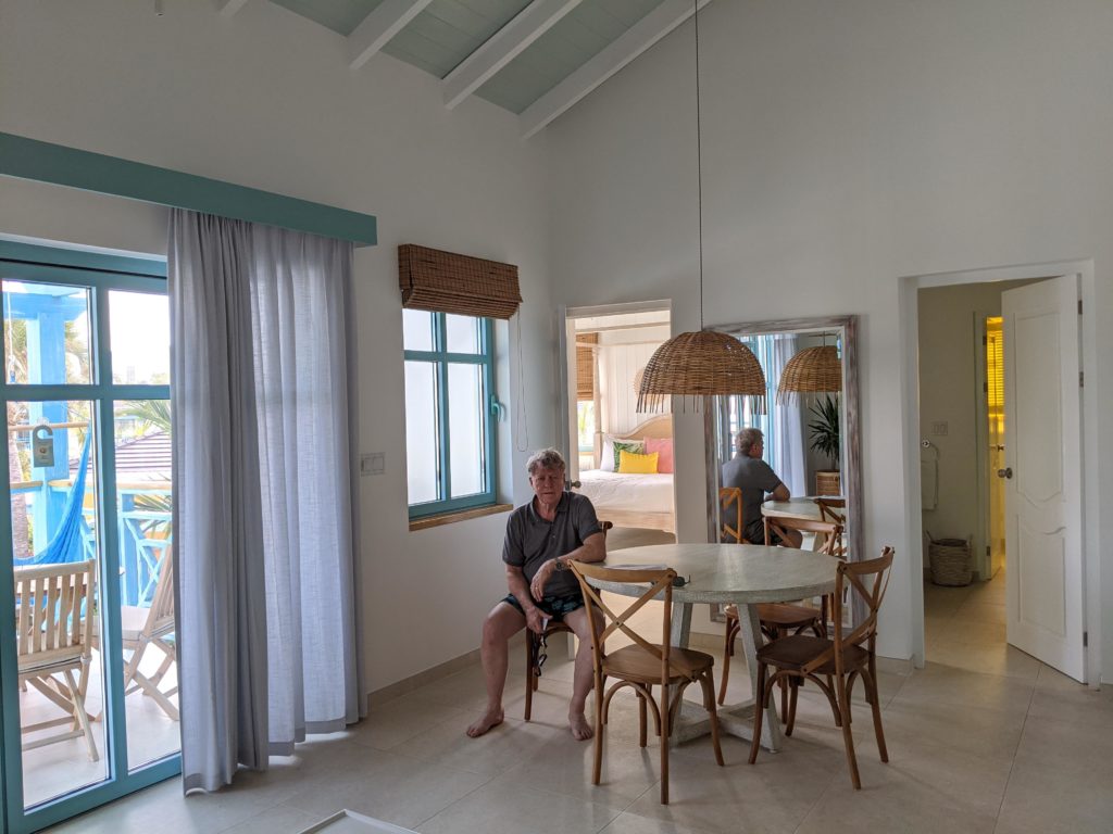 Man in a one-bedroom suite at the Boardwalk Boutique Hotel Aruba. - traveling to aruba checklist