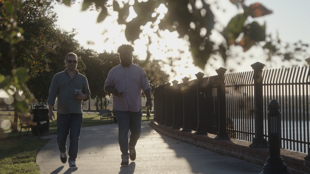 Two men walking along the Natchez waterfront.