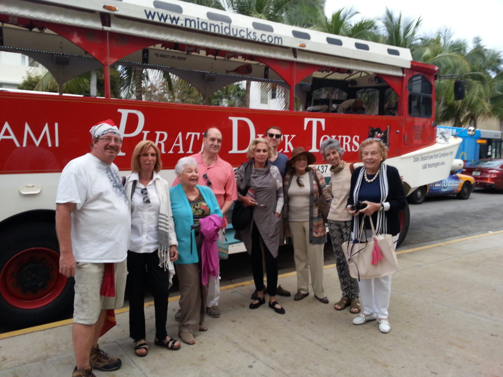 Group posing with guide in front of Miami Pirate Duck tours amphibious vehicle.