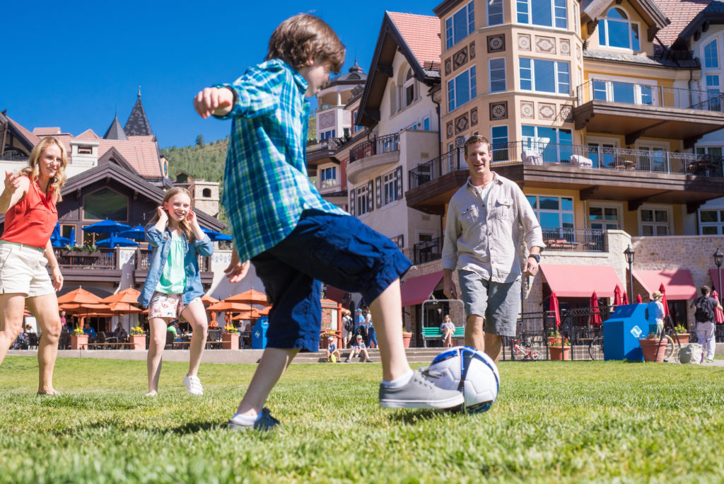 Casual family soccer game in the town square at Vail base village.