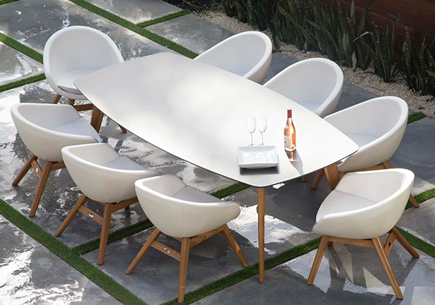 White table and chairs on a patio.
