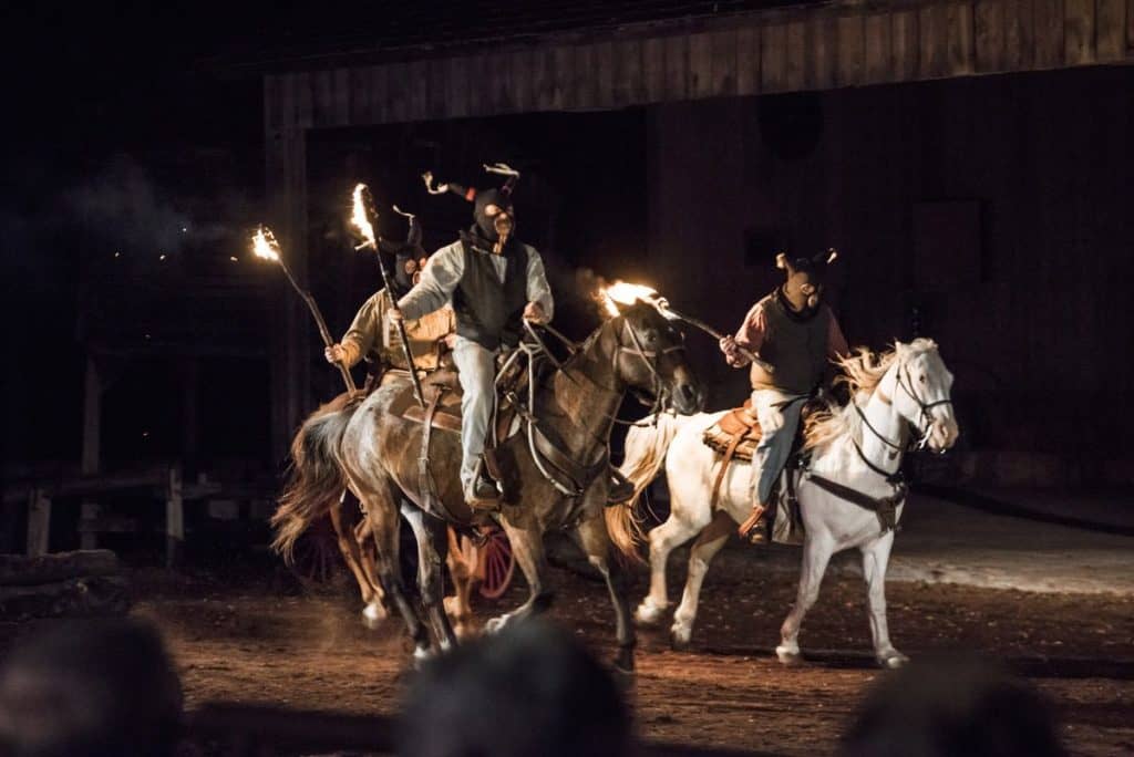 Riders on horseback carrying torches for the Shpeherd of the Hills outdoor drama.