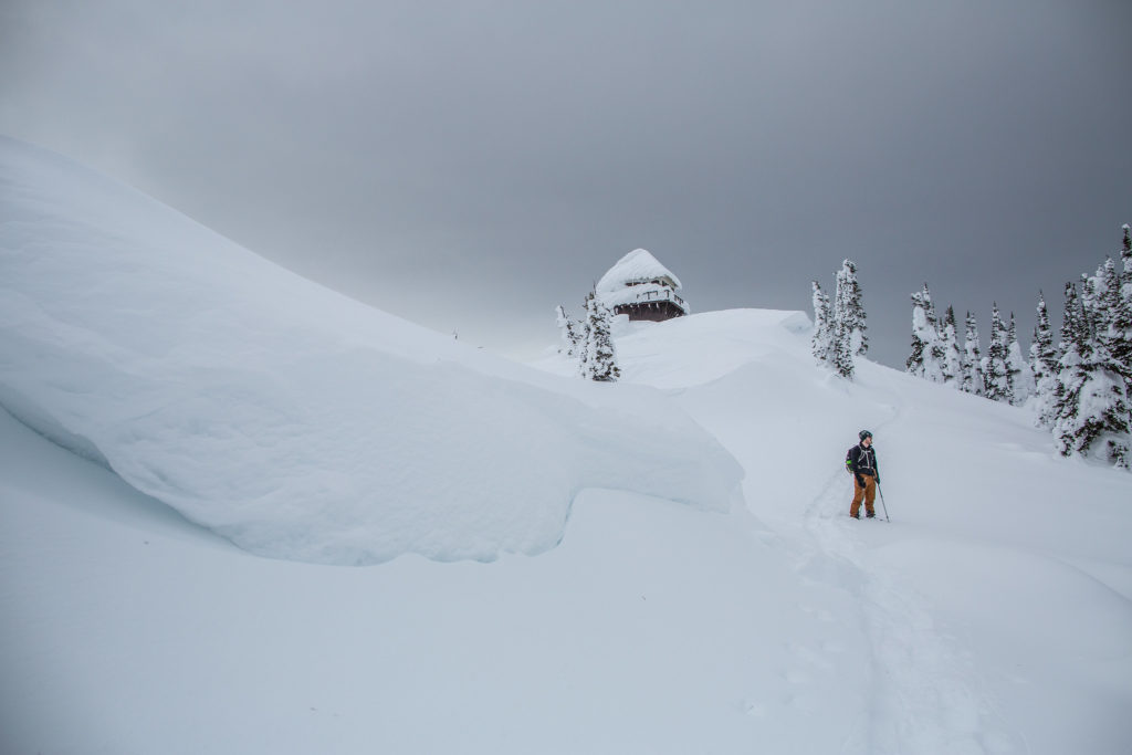 Man snowshoes in Glacier National Park below the Mount Brown Lookout.