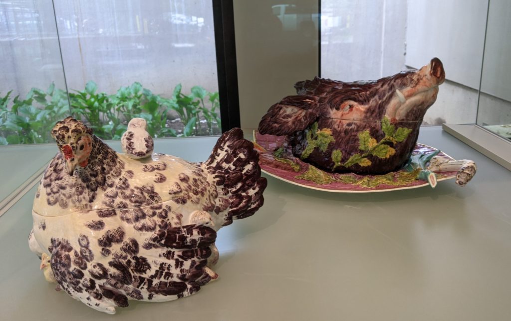 Historic chicken and pig shaped soup tureens on display at Winterthur Galleries, Wilmington, Delaware.