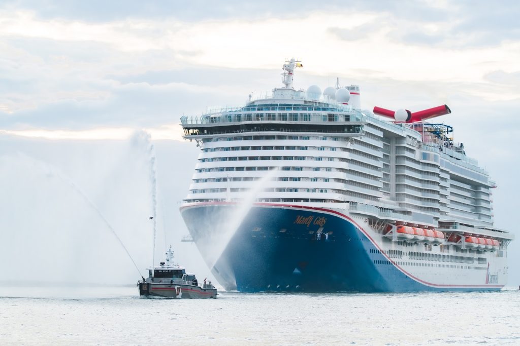 The Carnival Mardi Gras is a new Carnival ship escorted into port by a tugboat.