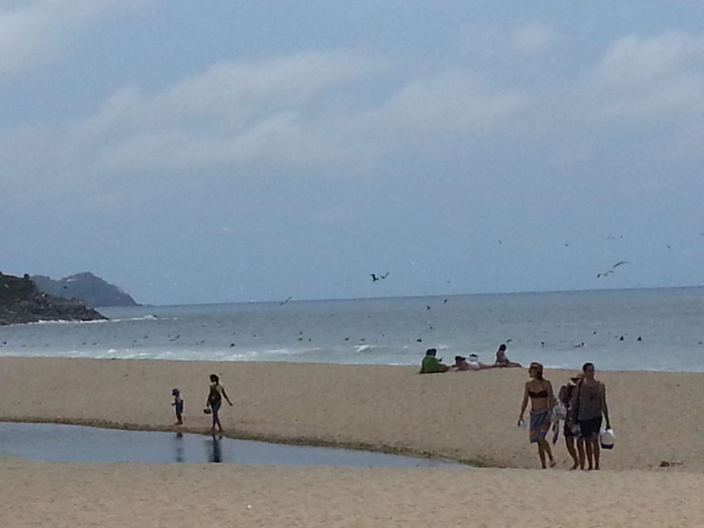 Beach-goers enjoy Sayulita Beach on Pacific Coast of Mexico.