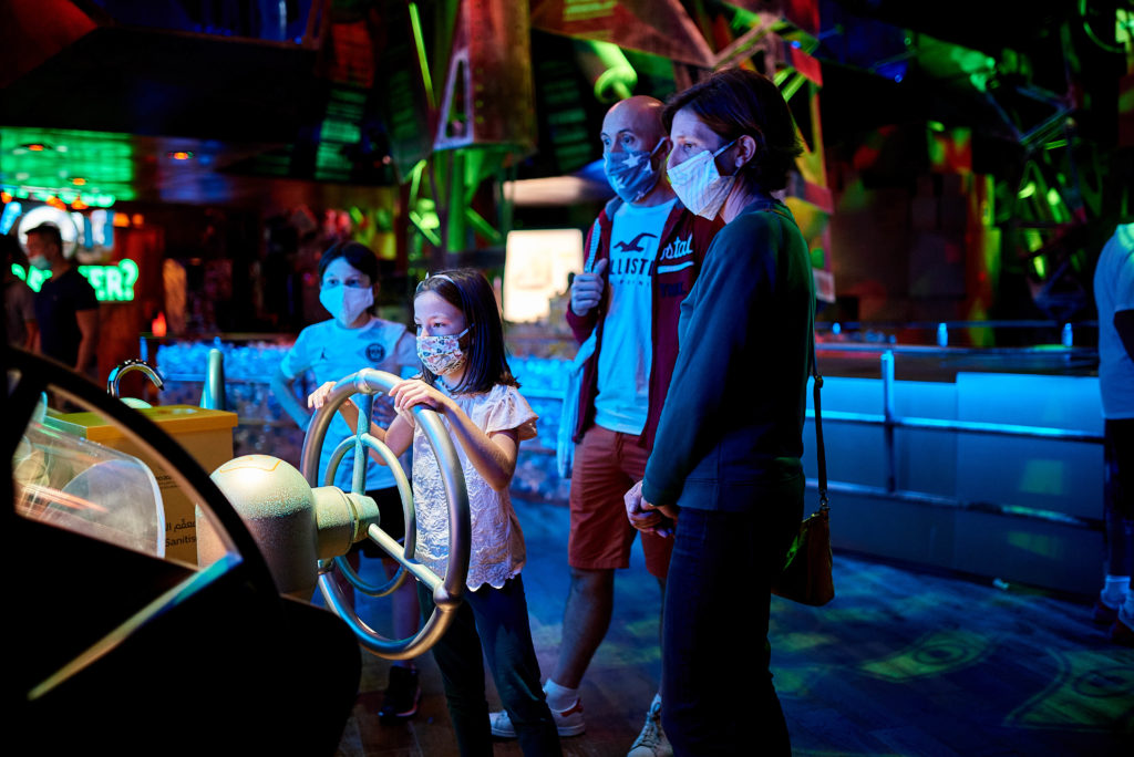 Family interacting with display at Terra, the Sustainability Pavilion.