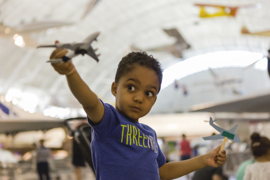 Henry, age 3, plays with a toy airplane during Flights of Fancy Story Time. Photo by Danile Sone, c. Smithsonian