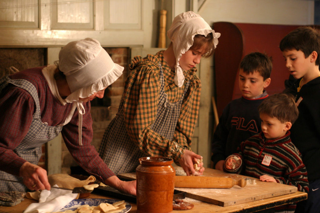 Costumed re-enactors prepare Thanksgiving dishes at Old Sturbridge Village in Massachusetts.