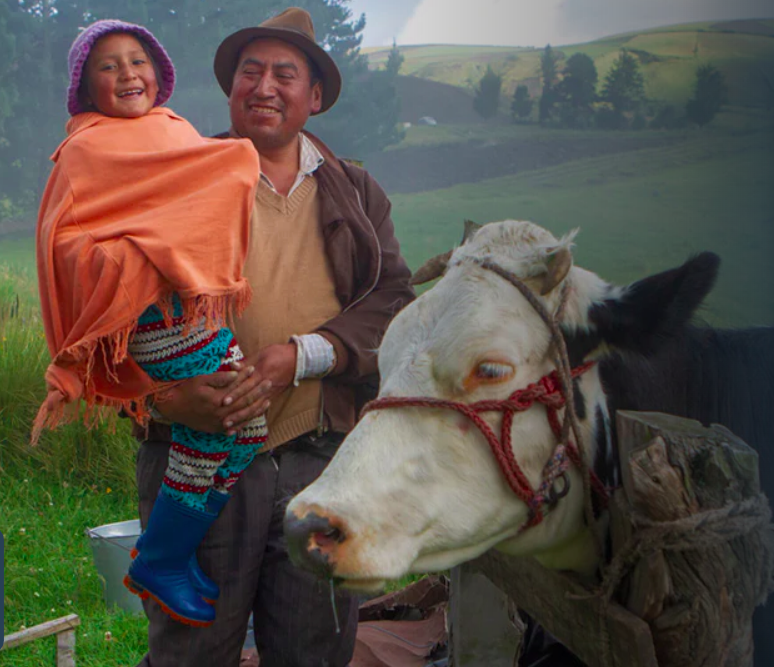 South American farmer with daughter and heifer.