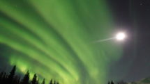 Aurora Borealis and full moon seen over Wiseman, Alaska.