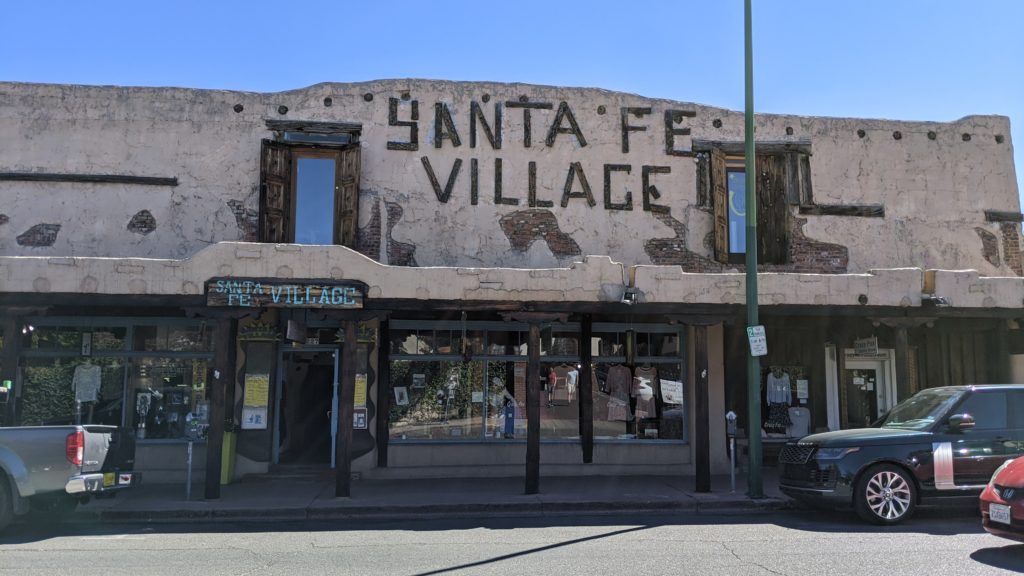Traditional trading post style pueblo architecture now houses a fashionable Santa Fe clothing boutique.