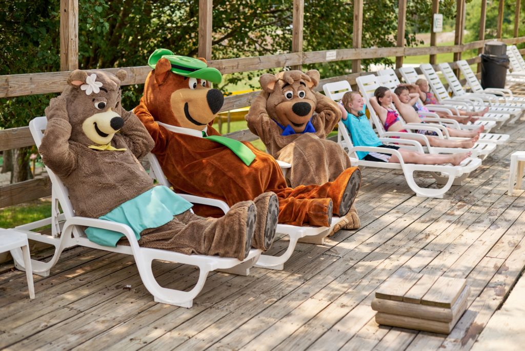 Yogi Bear and kids by swimming pool