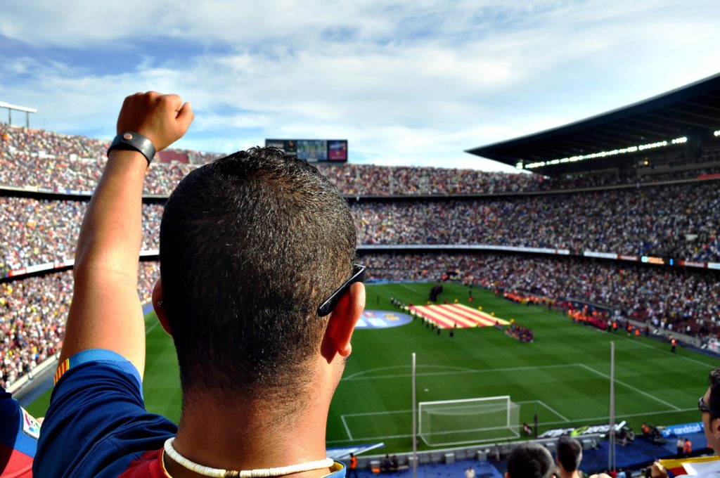Man watching a soccer game at Camp Nou, the famous football stadium in Barcelona.