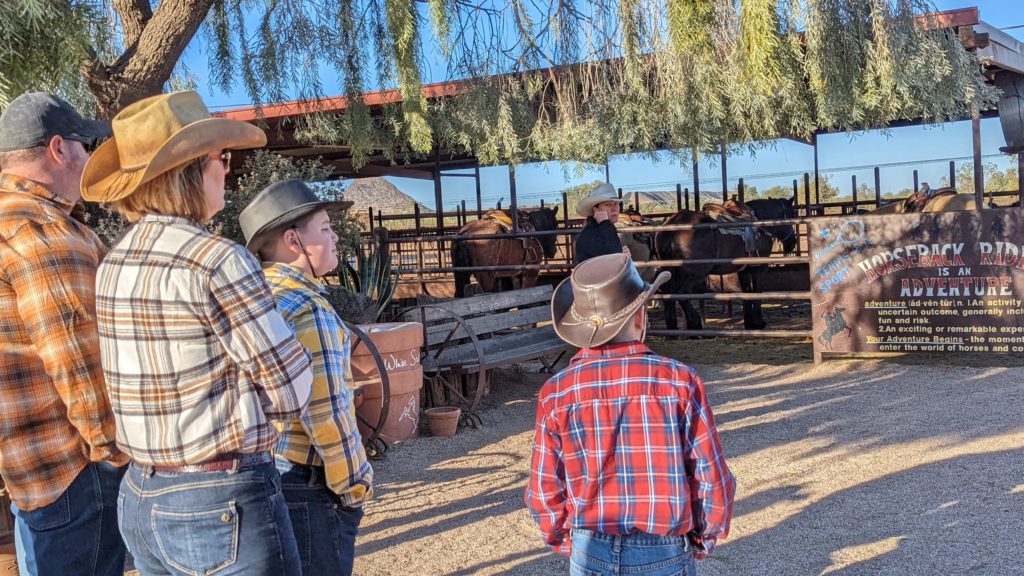 Family waits to select their horses for a horseback ride at White Stallion Ranch in Arizona.
