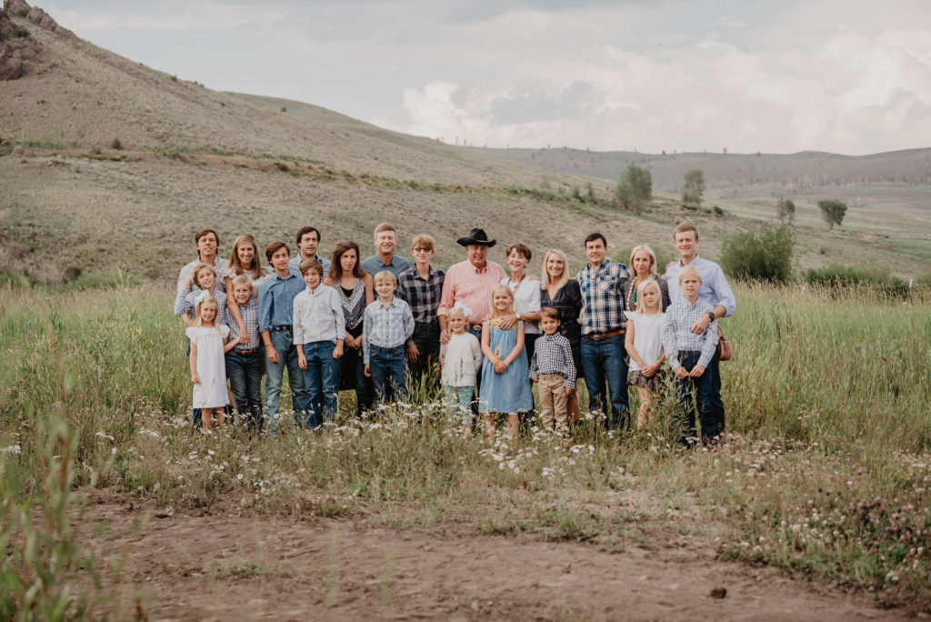 Family reunion in a field at C Lazy U Ranch in Colorado. Photo by J. Lee Photography for the Dude Ranchers Assocation.