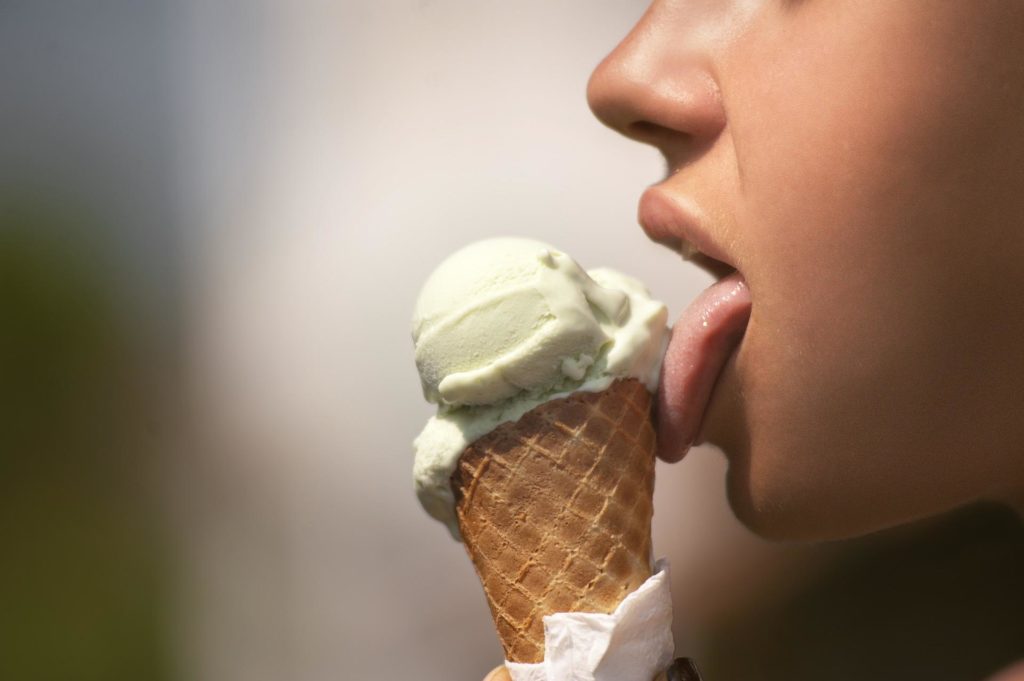 Girl licking ice cream cone