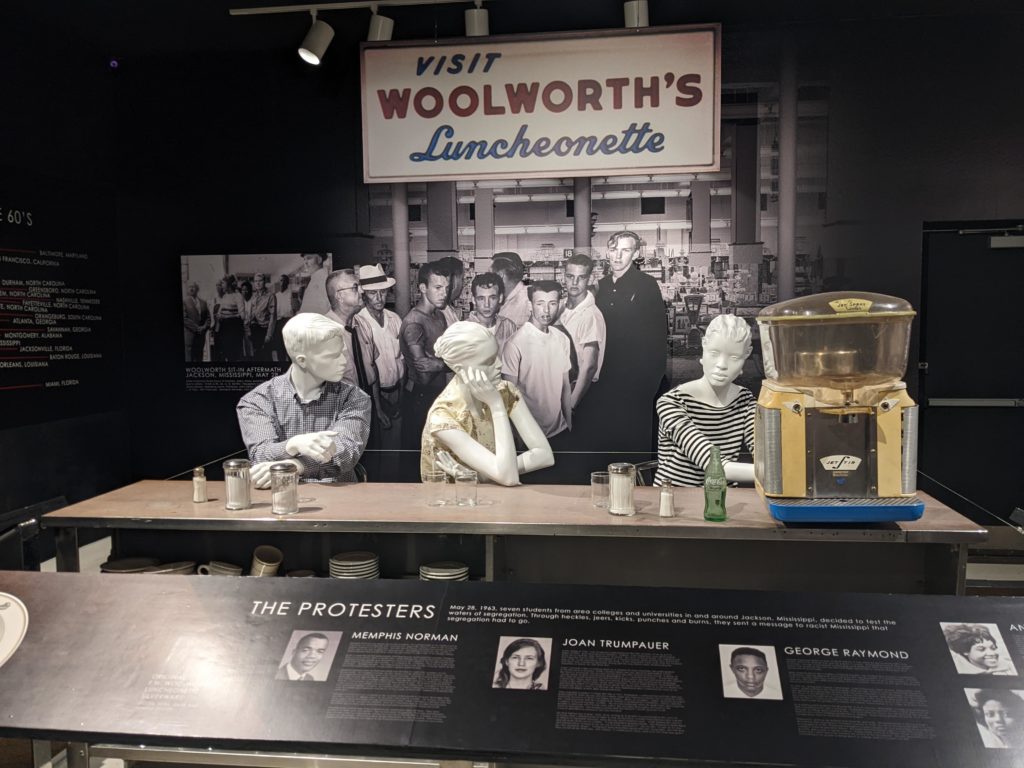Reproduction of the counter and three protesters who staged the sit in at Woolworth's lunch counter in Jackson, Mississippi.