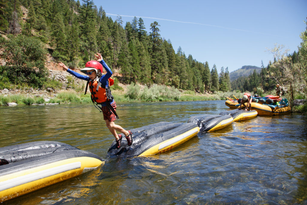 Boys jumps off an OARS river raft in the Lower Klamath River.